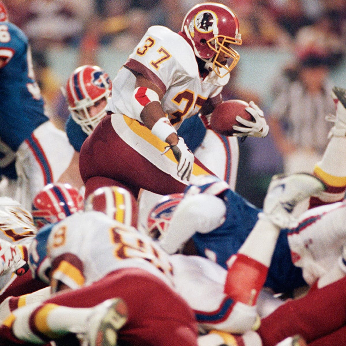 Washington Redskins running back Gerald Riggs (#37) carries the football through the Buffalo Bills defense during Super Bowl XXVI
