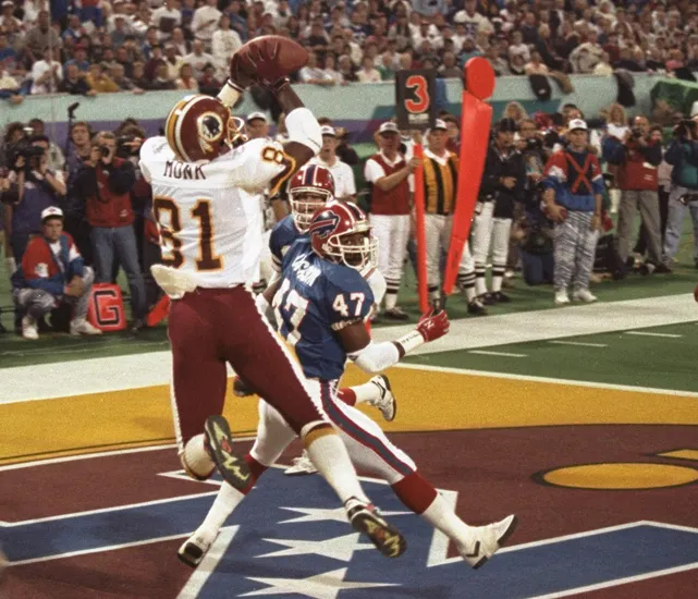 Washington Redskins wide receiver Art Monk (#81) leaps to catch a pass in the end zone against Buffalo Bills defenders during Super Bowl XXVI
