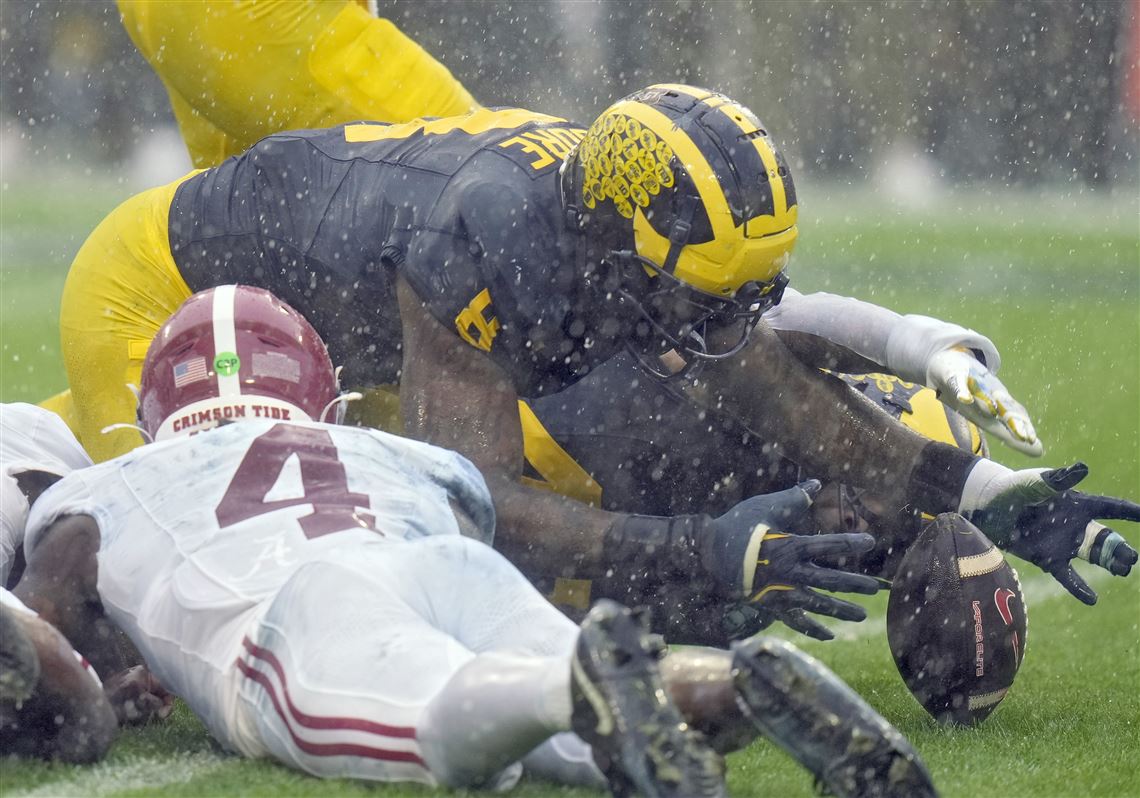 Alabama players fumbling the ball and Michigan recovering during the Bowl game.